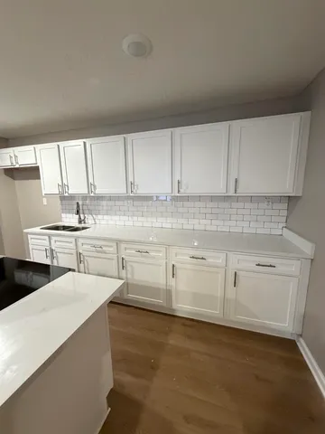 a kitchen with stainless steel appliances a white stove top oven sink and cabinets
