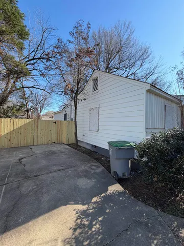 a backyard of a house with plants and trees