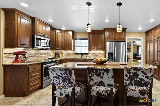 a kitchen with a stove oven and a sink