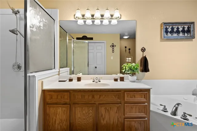 a bathroom with a granite countertop sink a large mirror and a toilet