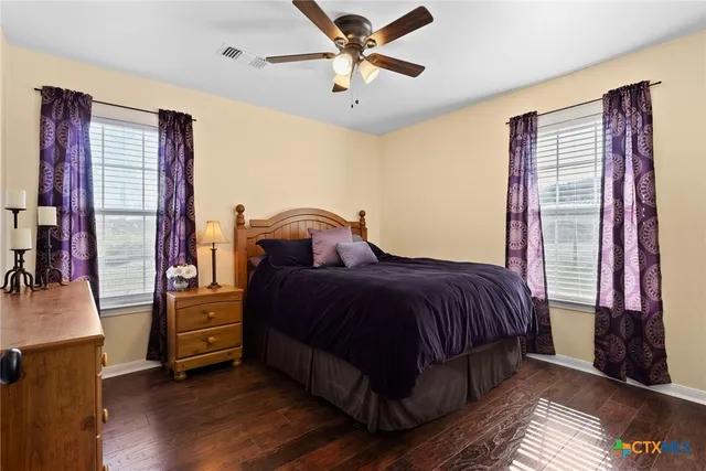 a bedroom with a bed and a large mirror