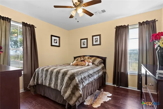a view of a patio with a table and chairs next to a yard