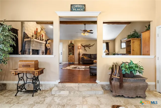 a bedroom with furniture and a large window