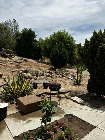 a view of a backyard with sitting area