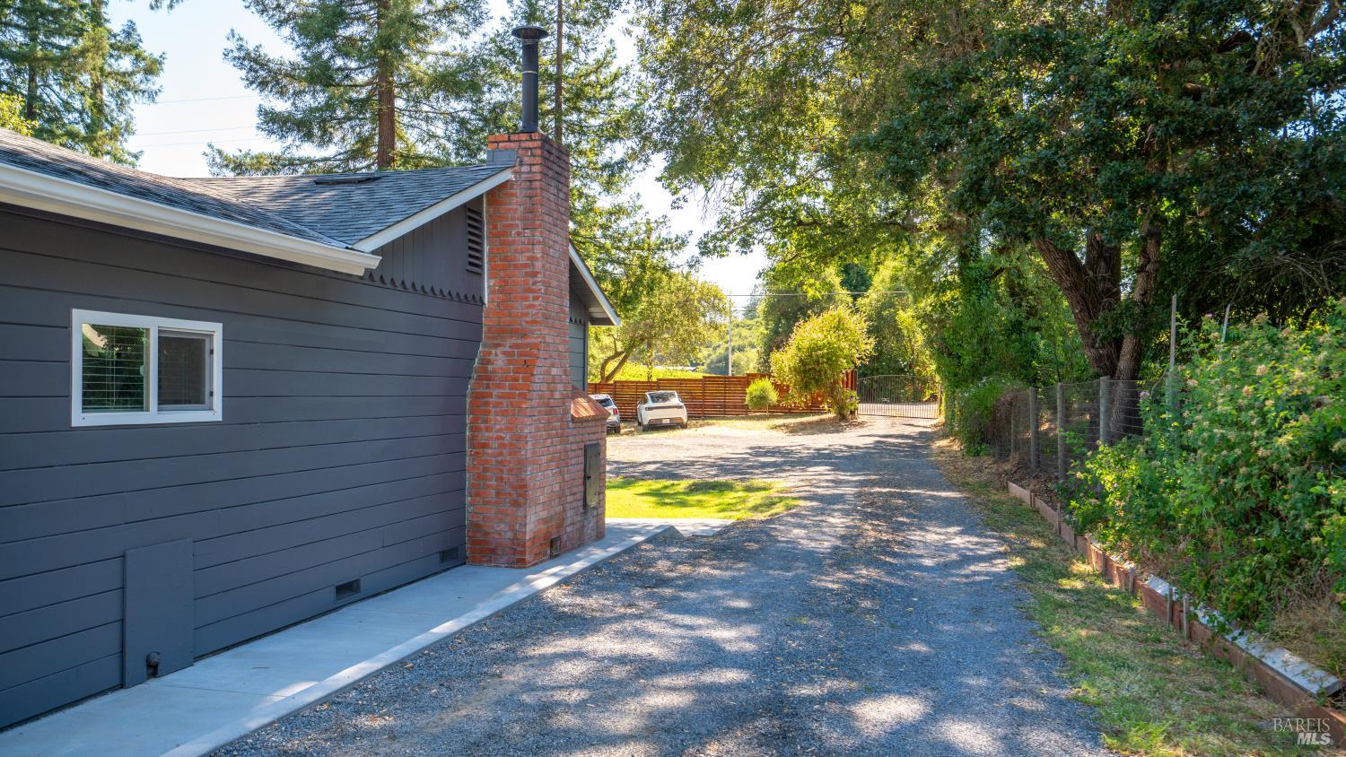 1550 Laguna Road Santa Rosa, CA 95401 - Photo 8 of 35 Driving up side of house to attached garage and backyard