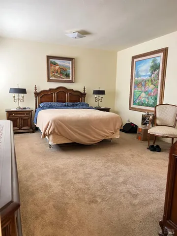 a living room with furniture and a book shelf
