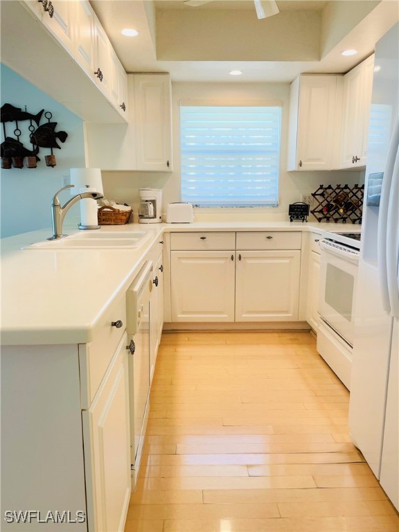 1020 South Collier Boulevard, Unit 507 Marco Island, FL 34145 - Photo 11 of 25 a kitchen with granite countertop white cabinets and white appliances