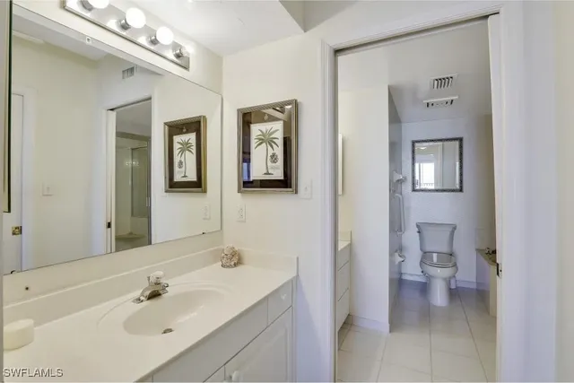 a bathroom with a shower a toilet and a sink