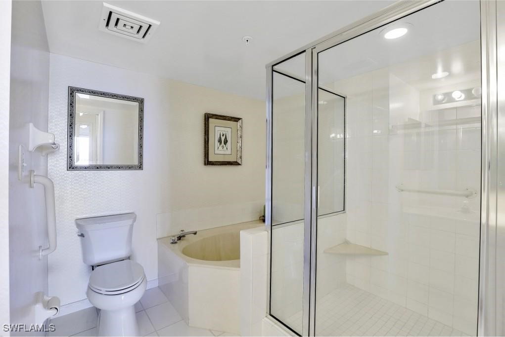 1020 South Collier Boulevard, Unit 507 Marco Island, FL 34145 - Photo 18 of 25 a bathroom with a shower a toilet and a sink