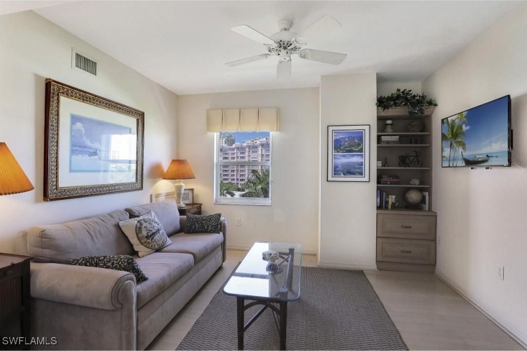 1020 South Collier Boulevard, Unit 507 Marco Island, FL 34145 - Photo 19 of 25 a living room with furniture and cabinets