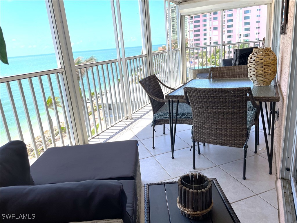 1020 South Collier Boulevard, Unit 507 Marco Island, FL 34145 - Photo 7 of 25 a view of a livingroom with furniture and a floor to ceiling window