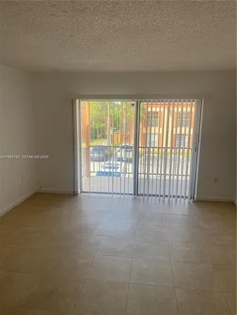 a view of an empty room with a floor to ceiling window