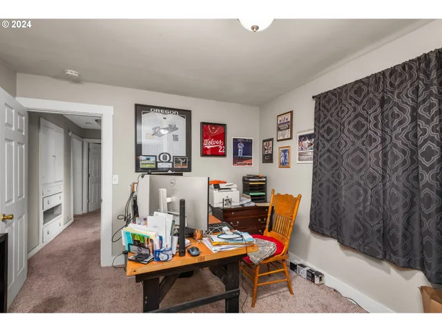 a living room with furniture and a dining table