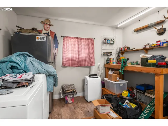 a living room with furniture and a baby crib