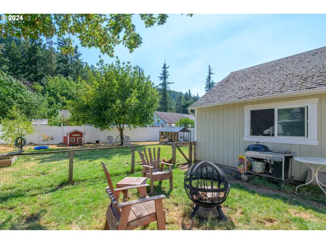 a backyard of a house with table and chairs