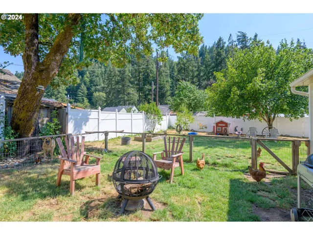 a view of house with backyard and outdoor seating