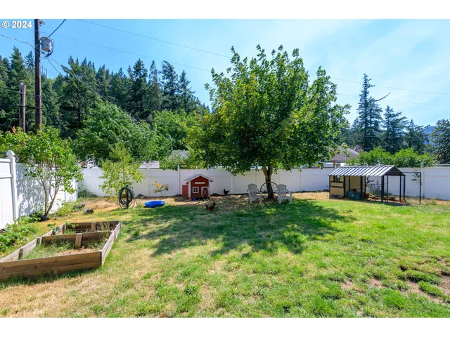 a backyard of a house with table and chairs