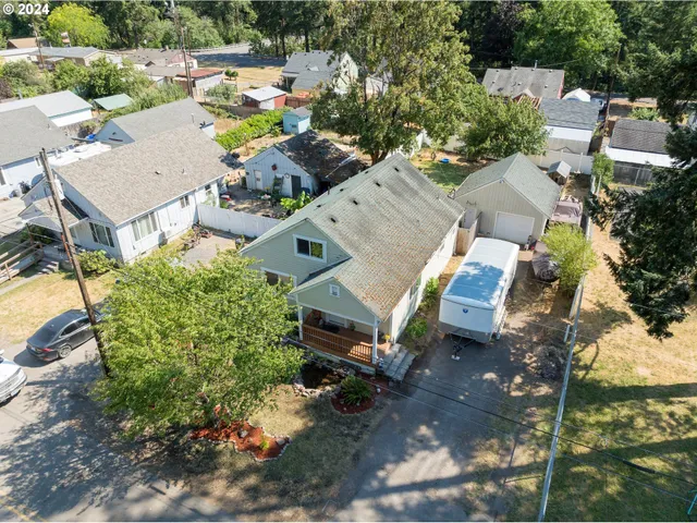 an aerial view of a house with a yard and lake view