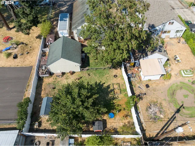 an aerial view of a house with a yard and garden