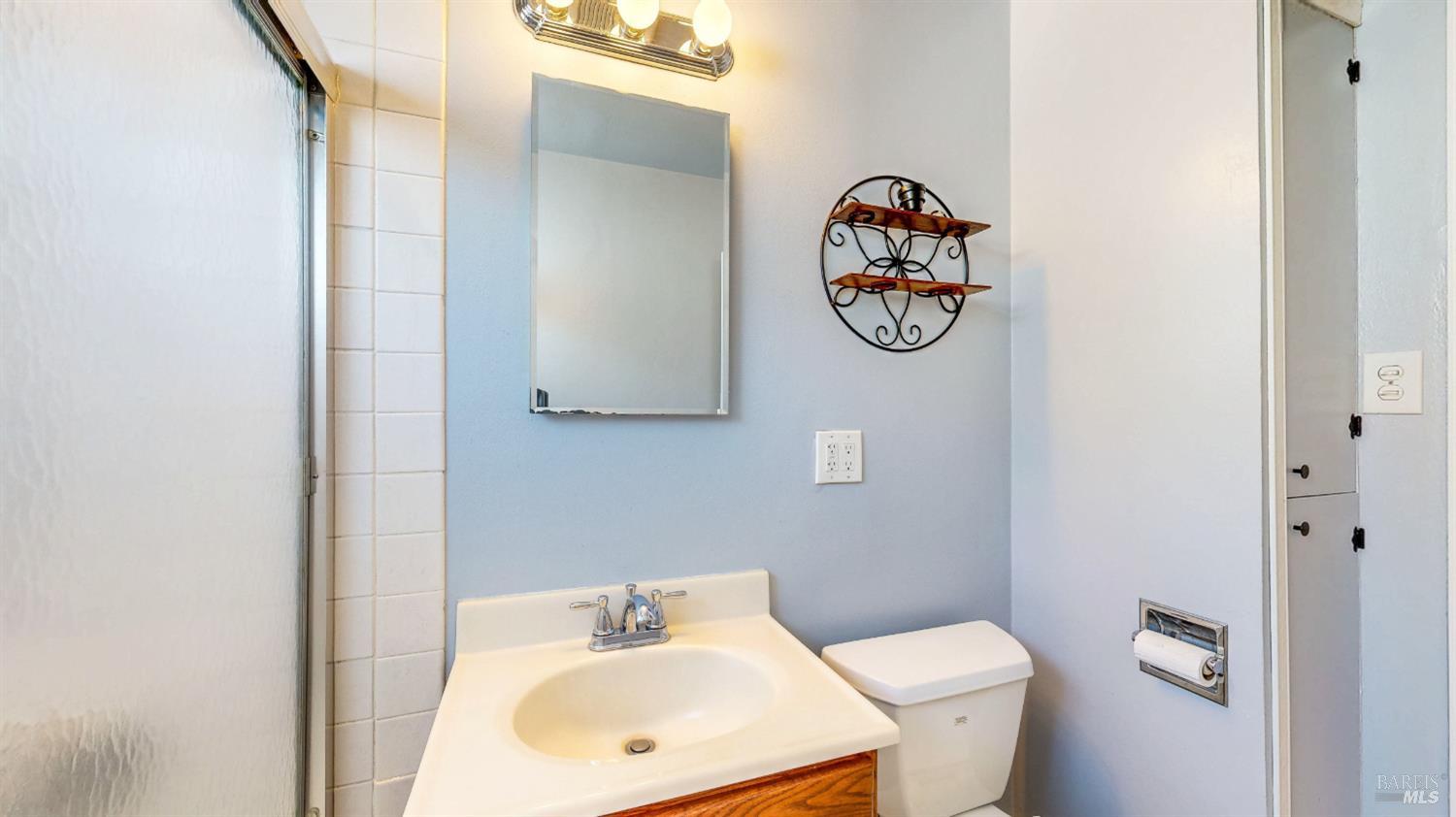 809 Maple Avenue Vallejo, CA 94591 - Photo 19 of 46 a bathroom with a toilet sink and mirror