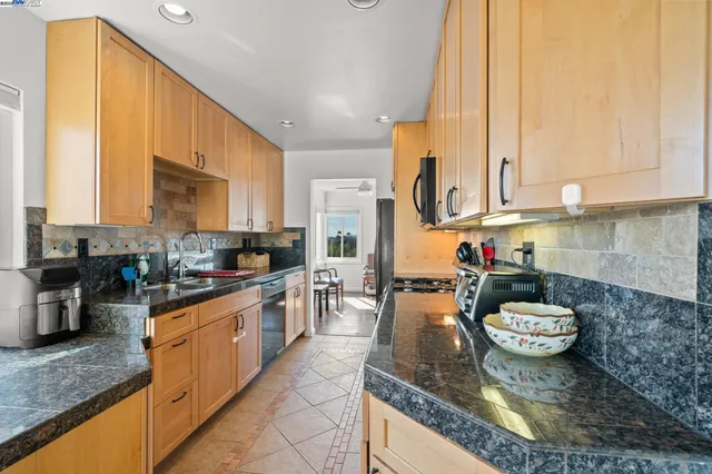 a kitchen with a sink a stove and cabinets