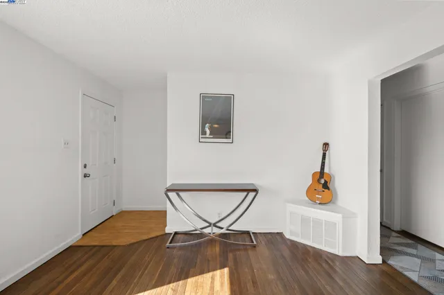 a living room with a couch and wooden floor