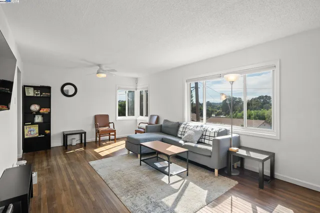 a living room with furniture and wooden floor