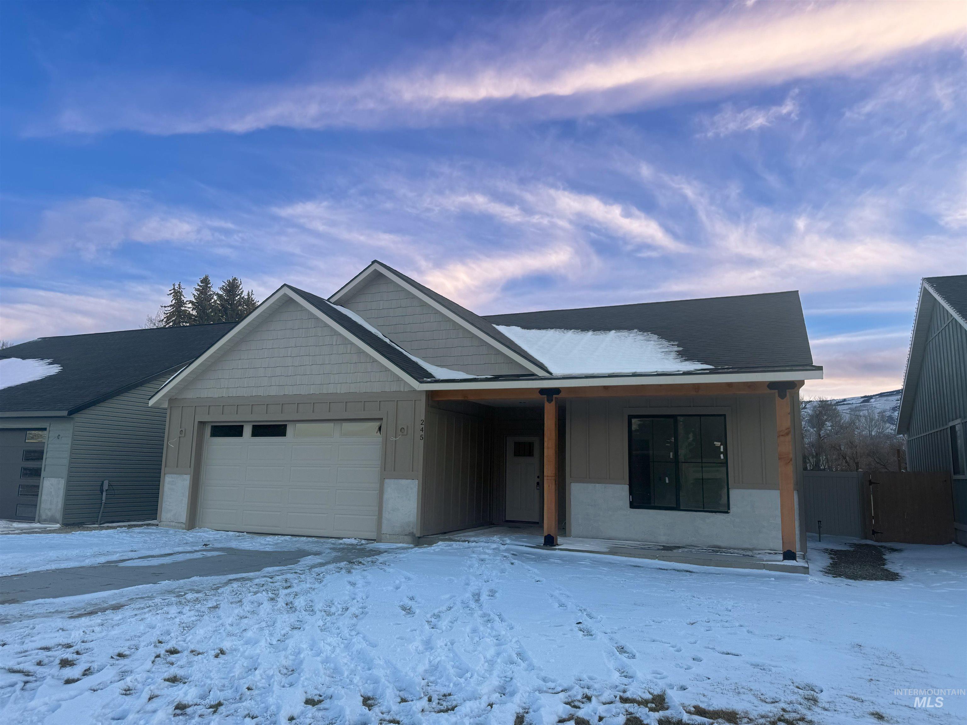 245 Whitman Street Albion, ID 83311 - Photo 2 of 8 View of front of house with board and batten siding and a garage