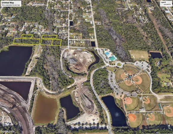 an aerial view of a swimming pool with outdoor seating