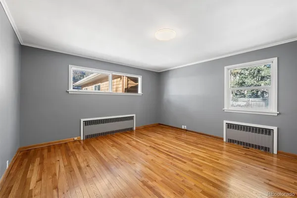 a view of room with window and wooden floor
