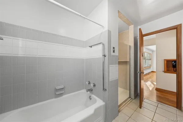 a bathroom with a bathtub and a shower