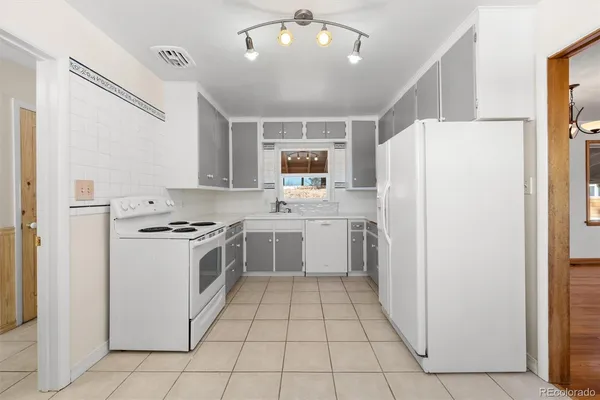 a kitchen with a stove a refrigerator and a sink
