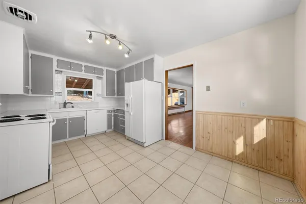 a kitchen with a refrigerator sink and stove