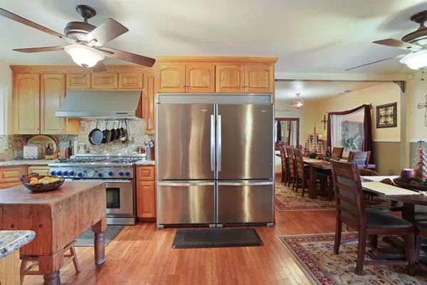 an aerial view of a house with a yard and lake view