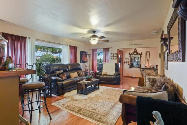 a kitchen with stainless steel appliances granite countertop a sink a stove and a wooden cabinets