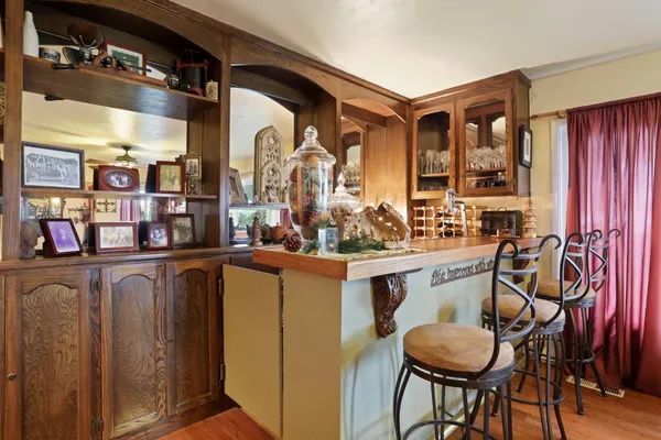 a view of a dining room with furniture a chandelier and wooden floor