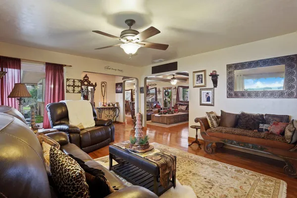 a view of a dining room with furniture a chandelier and wooden floor