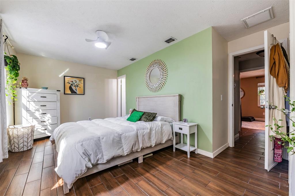 611 St Henry Drive Brandon, FL 33511 - Photo 18 of 34 a bedroom with a bed and a chandelier