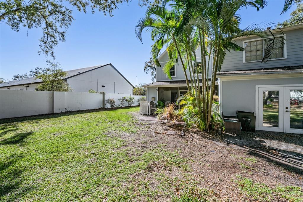 611 St Henry Drive Brandon, FL 33511 - Photo 26 of 34 a view of a house with potted plants and a large tree