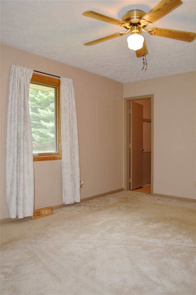 5642 Gray Eagle Road Roscoe, IL 61073 - Photo 7 of 15 an empty room with windows and fan