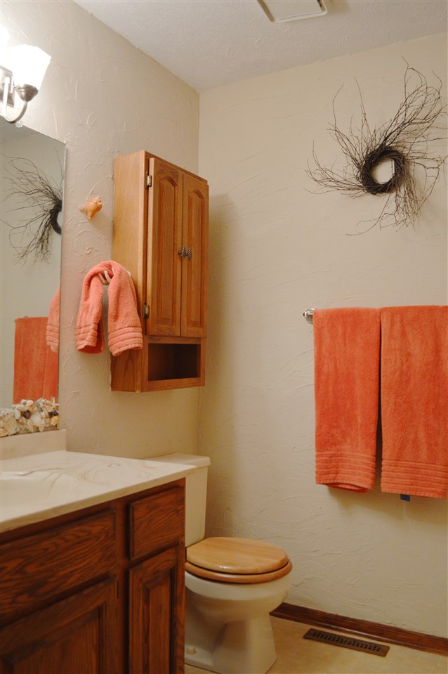 5642 Gray Eagle Road Roscoe, IL 61073 - Photo 10 of 15 a bathroom with a sink a mirror and toilet