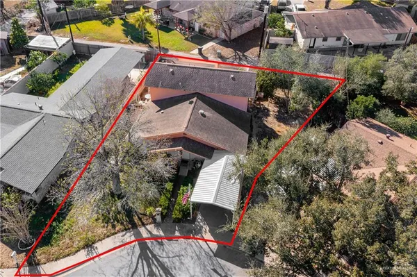 an aerial view of a house with a yard and garden