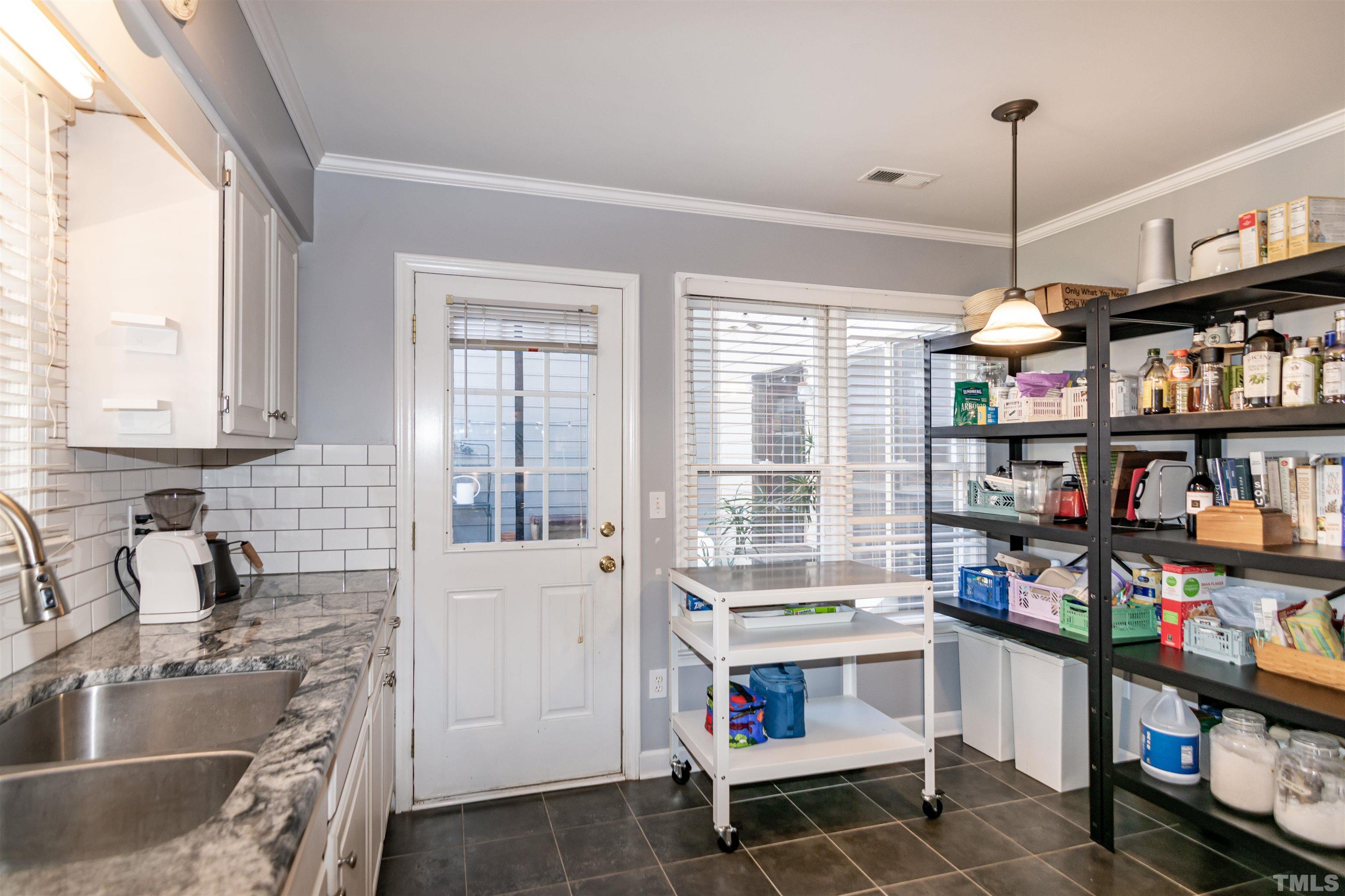 6722 Twin Tree Court Raleigh, NC 27613 - Photo 13 of 33 a kitchen that has a lot of cabinets and a wooden floor