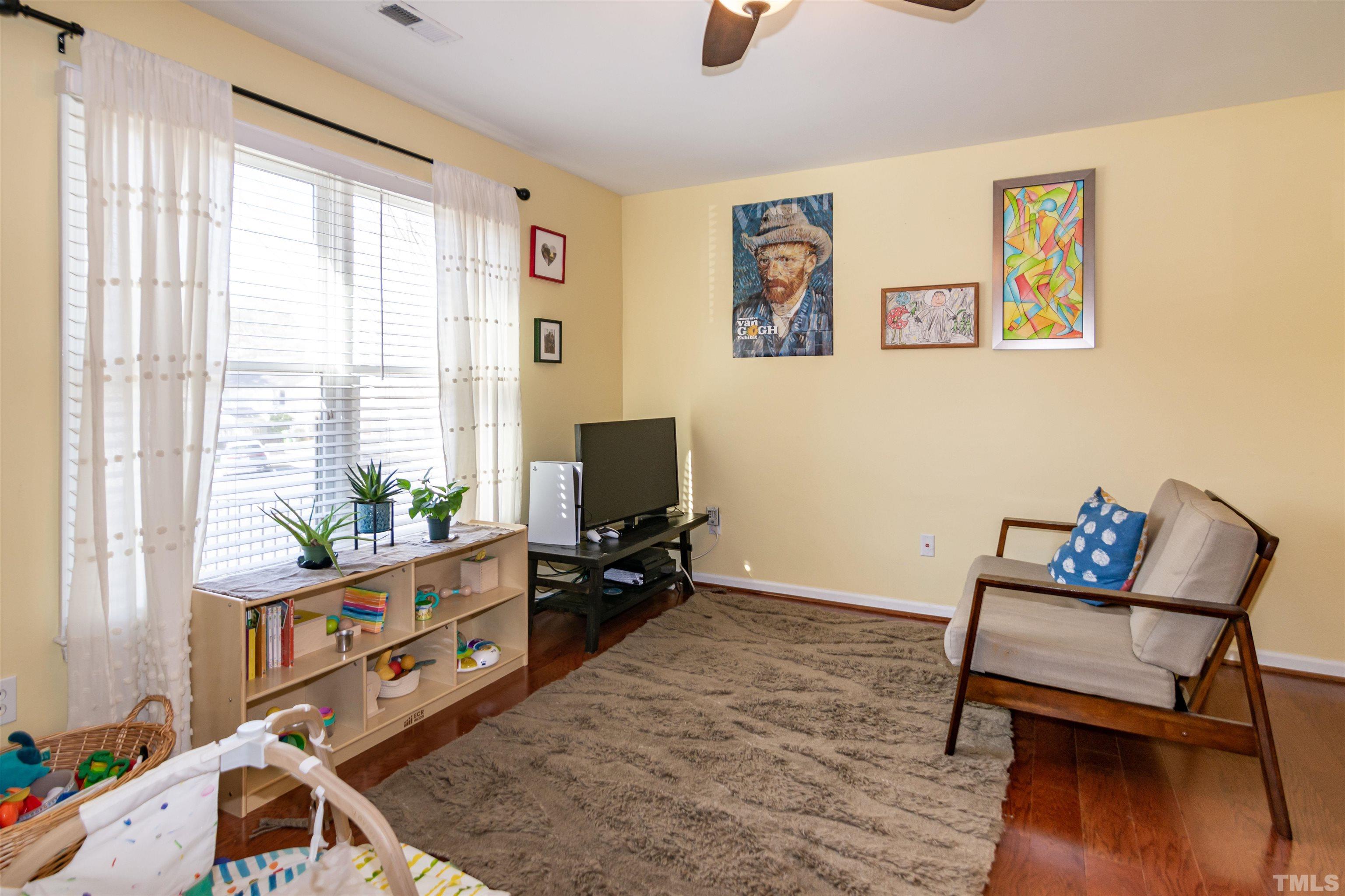 6722 Twin Tree Court Raleigh, NC 27613 - Photo 15 of 33 a living room with furniture and a flat screen tv