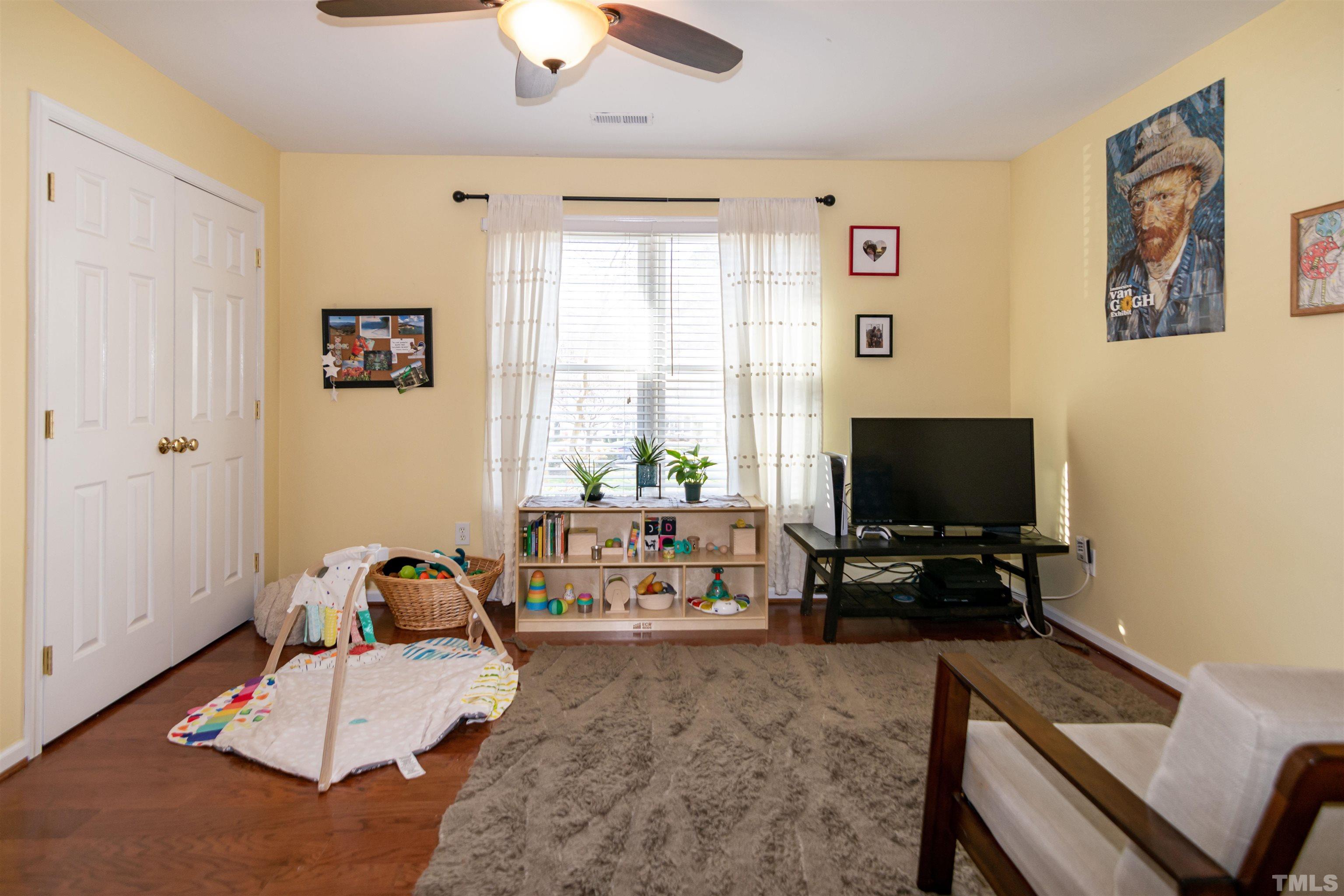 6722 Twin Tree Court Raleigh, NC 27613 - Photo 16 of 33 a living room with furniture and a flat screen tv