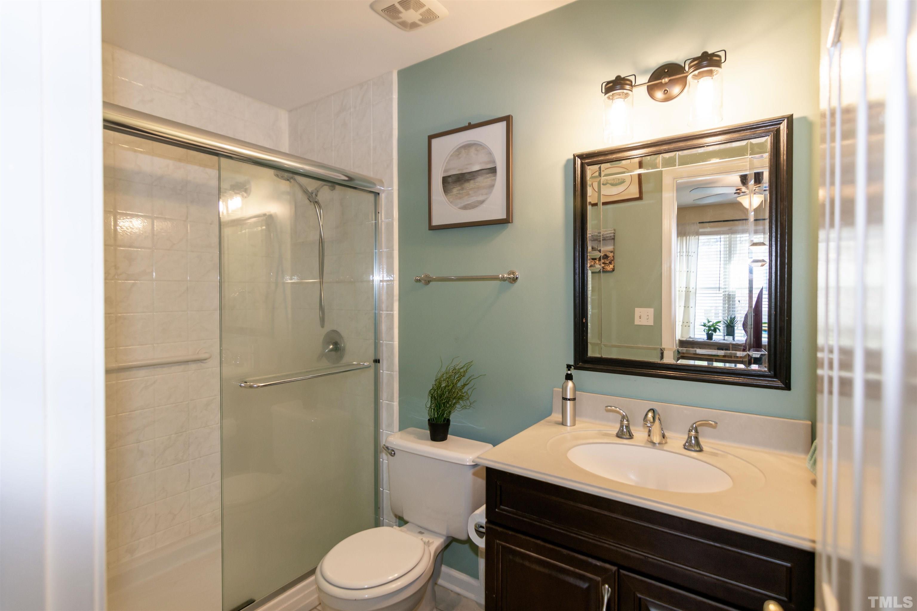 6722 Twin Tree Court Raleigh, NC 27613 - Photo 18 of 33 a bathroom with a sink a toilet and shower