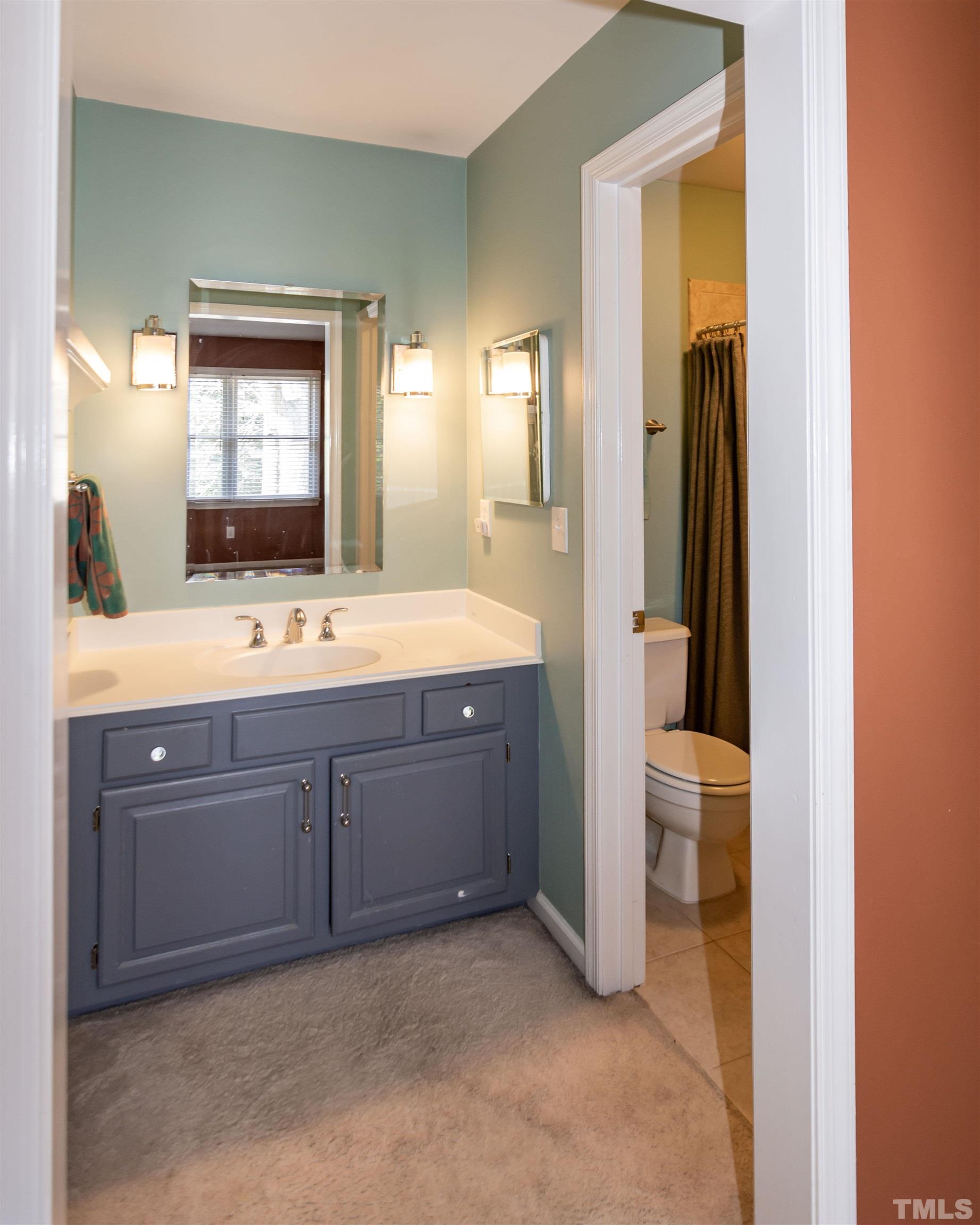 6722 Twin Tree Court Raleigh, NC 27613 - Photo 22 of 33 a spacious bathroom with a double vanity sink and a mirror