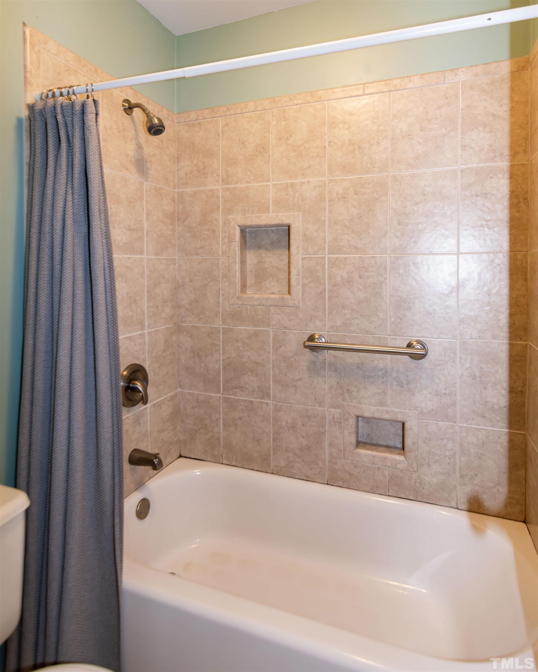 6722 Twin Tree Court Raleigh, NC 27613 - Photo 24 of 33 a bathroom with a shower and a bath tub