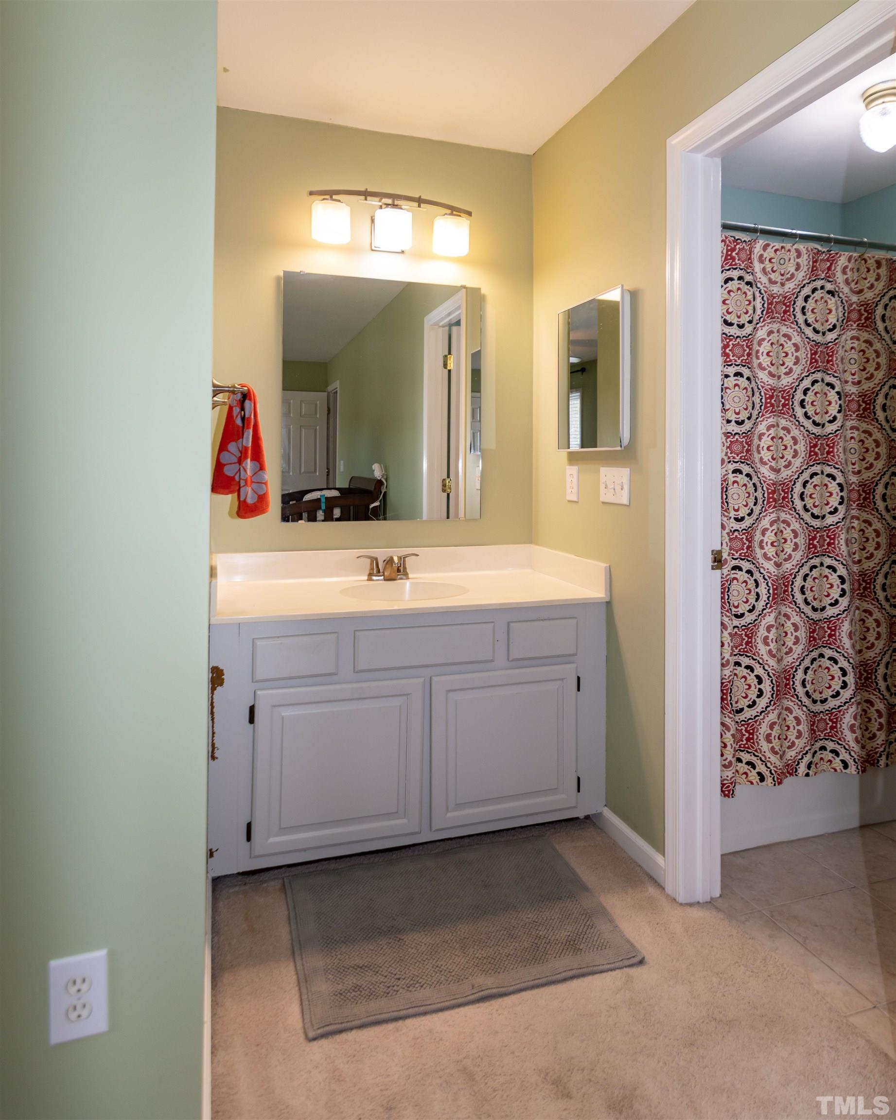 6722 Twin Tree Court Raleigh, NC 27613 - Photo 28 of 33 a spacious bathroom with a mirror sink and vanity