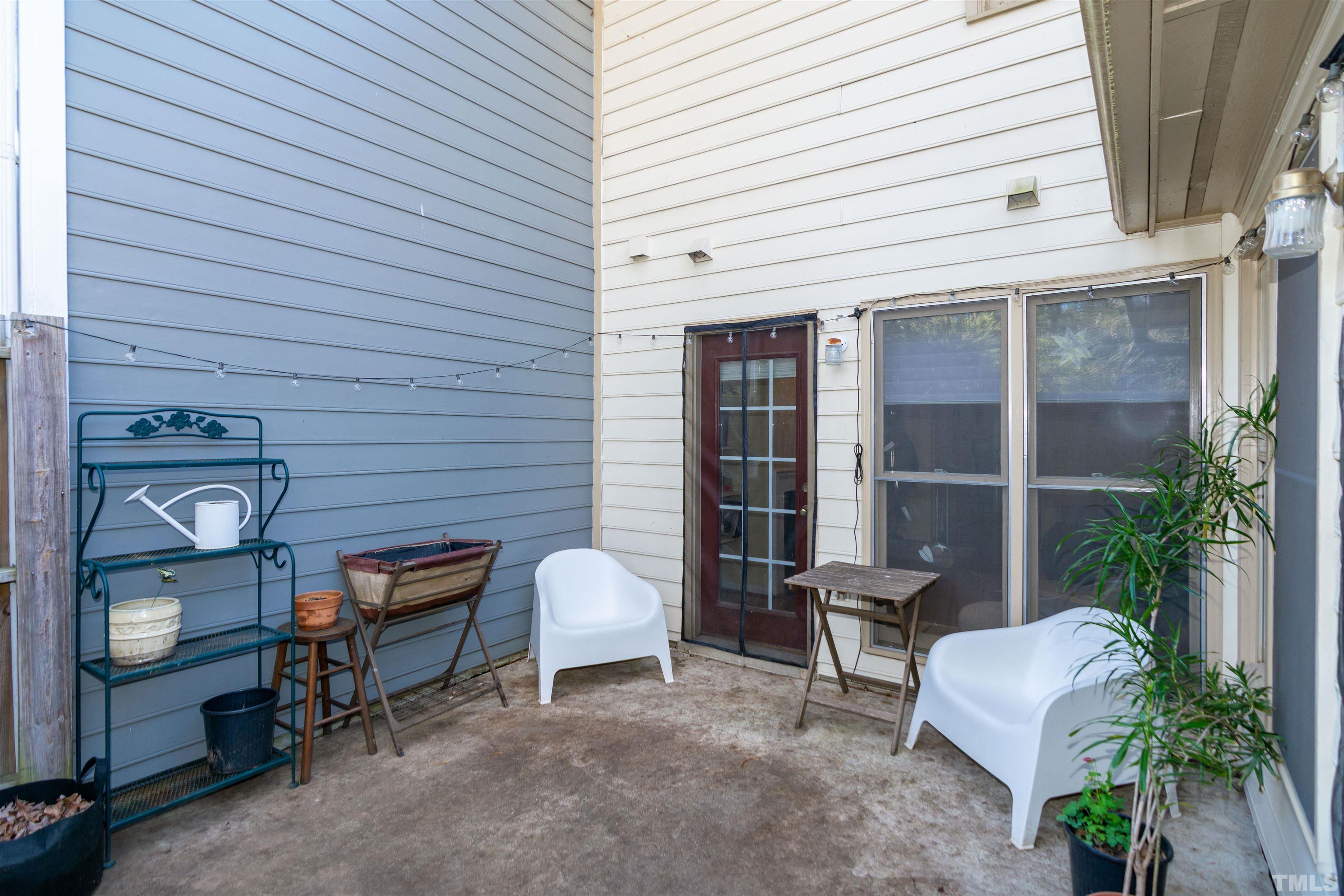 6722 Twin Tree Court Raleigh, NC 27613 - Photo 29 of 33 a view of a patio with table and chairs and potted plants
